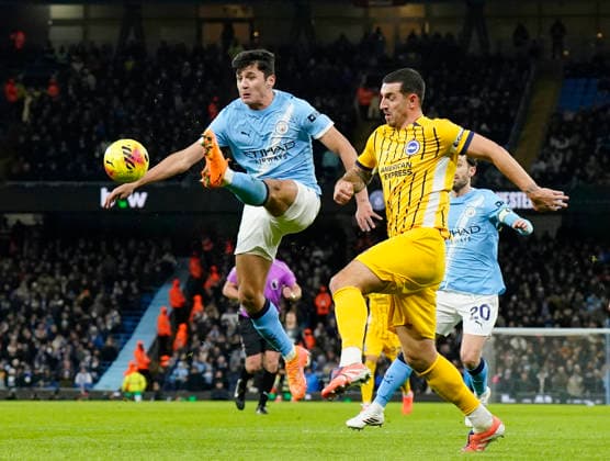 Manchester, England, 7th January 2026. Abdukodir Khusanov of Manchester City clears under pressure from Lewis Dunk of Brighton during the Manchester City vs Brighton and Hove Albion Premier League match at the Etihad Stadium, Manchester. Picture credit should read: Andrew Yates Sportimage EDITORIAL USE ONLY. No use with unauthorised audio, video, data, fixture lists, club league logos or live services. Online in-match use limited to 120 images, no video emulation. No use in betting, games or single club league player publications. SPI_030_AY_Man_City_Brighton SPI-4435-0030