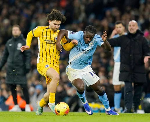 Manchester, England, 7th January 2026. Ferdi KadÄ±oglu of Brighton (l) tackles Jeremy Doku of Manchester City (r) during the Manchester City vs Brighton and Hove Albion Premier League match at the Etihad Stadium, Manchester. Picture credit should read: Andrew Yates Sportimage EDITORIAL USE ONLY. No use with unauthorised audio, video, data, fixture lists, club league logos or live services. Online in-match use limited to 120 images, no video emulation. No use in betting, games or single club league player publications. SPI_050_AY_Man_City_Brighton SPI-4435-0050