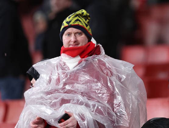 London, England, 8th January 2026. An Arsenal fans takes cover from the torrential rain during the Arsenal vs Liverpool Premier League match at the Emirates Stadium, London. Picture credit should read: David Klein Sportimage EDITORIAL USE ONLY. No use with unauthorised audio, video, data, fixture lists, club league logos or live services. Online in-match use limited to 120 images, no video emulation. No use in betting, games or single club league player publications. SPI_006_DK_Arsenal_Liverpool SPI-4439-0006