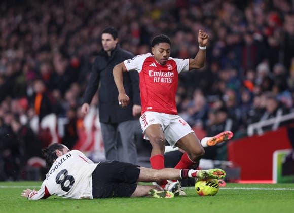 London, England, 8th January 2026. Myles Lewis-Skelly of Arsenal tackled by Dominik Szoboszlai of Liverpool during the Arsenal vs Liverpool Premier League match at the Emirates Stadium, London. Picture credit should read: David Klein Sportimage EDITORIAL USE ONLY. No use with unauthorised audio, video, data, fixture lists, club league logos or live services. Online in-match use limited to 120 images, no video emulation. No use in betting, games or single club league player publications. SPI_041_DK_Arsenal_Liverpool SPI-4439-0041
