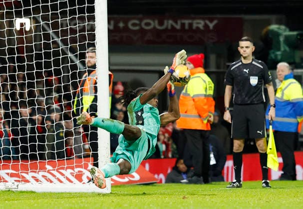 Wrexham, Wales, 9th January 2026. Arthur Okonkwo of Wrexham saves the penalty to send them through during the Wrexham vs Nottingham Forest FA Cup third round match at the SToK Cae Ras, Wrexham. Picture credit should read: Cody Froggatt Sportimage EDITORIAL USE ONLY. No use with unauthorised audio, video, data, fixture lists, club league logos or live services. Online in-match use limited to 120 images, no video emulation. No use in betting, games or single club league player publications. SPI_073_CF_Wrexham_Forest SPI-4440-0076