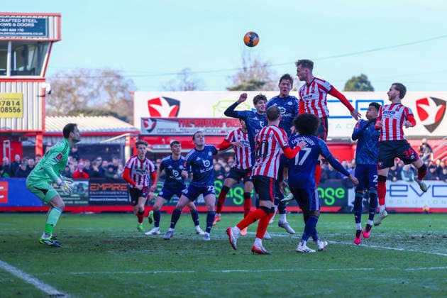 Cheltenham Town v Leicester City, FA Cup, 3rd Round Cheltenham Town defender Robbie Cundy (6) heads over the bar during the FA Cup match between Cheltenham Town and Leicester City at EV Charger Points Stadium, Cheltenham, UK on 10 January 2026. Cheltenham Jonny Rocks Stadium Gloucestershire UK Editorial use only DataCo restrictions apply See www.football-dataco.com , Copyright: xJohnxMallettx PSI-23561-0054