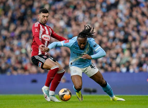 Manchester, England, 10th January 2026. Reece Cole of Exeter City tussles with Antoine Semenyo of Manchester City during the Manchester City vs Exeter City FA Cup match at the Etihad Stadium, Manchester. Picture credit should read: Andrew Yates Sportimage EDITORIAL USE ONLY. No use with unauthorised audio, video, data, fixture lists, club league logos or live services. Online in-match use limited to 120 images, no video emulation. No use in betting, games or single club league player publications. SPI_018_AY_Man_City_Exeter SPI-4442-0017
