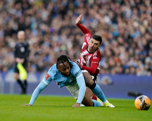 Manchester, England, 10th January 2026. Reece Cole of Exeter City tussles with Antoine Semenyo of Manchester City during the Manchester City vs Exeter City FA Cup match at the Etihad Stadium, Manchester. Picture credit should read: Andrew Yates Sportimage EDITORIAL USE ONLY. No use with unauthorised audio, video, data, fixture lists, club league logos or live services. Online in-match use limited to 120 images, no video emulation. No use in betting, games or single club league player publications. SPI_020_AY_Man_City_Exeter SPI-4442-0019