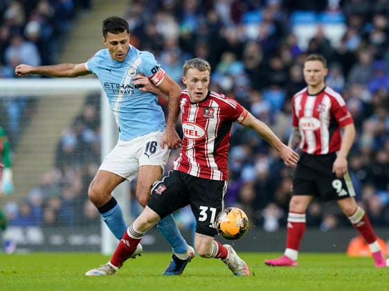 Manchester, England, 10th January 2026. Rodri of Manchester City tackles Jake Doyle-Hayes of Exeter City during the Manchester City vs Exeter City FA Cup match at the Etihad Stadium, Manchester. Picture credit should read: Andrew Yates Sportimage EDITORIAL USE ONLY. No use with unauthorised audio, video, data, fixture lists, club league logos or live services. Online in-match use limited to 120 images, no video emulation. No use in betting, games or single club league player publications. SPI_024_AY_Man_City_Exeter SPI-4442-0023