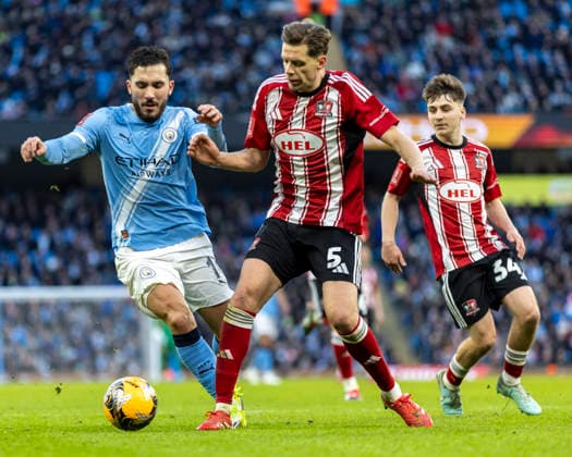 10th January 2026; Etihad Stadium, Manchester, Lancashire, England; FA Cup Football, Manchester City versus Exeter City; Jack Fitzwater of Exeter City under pressure from Rayan Cherki of Manchester City  TimxWilliams