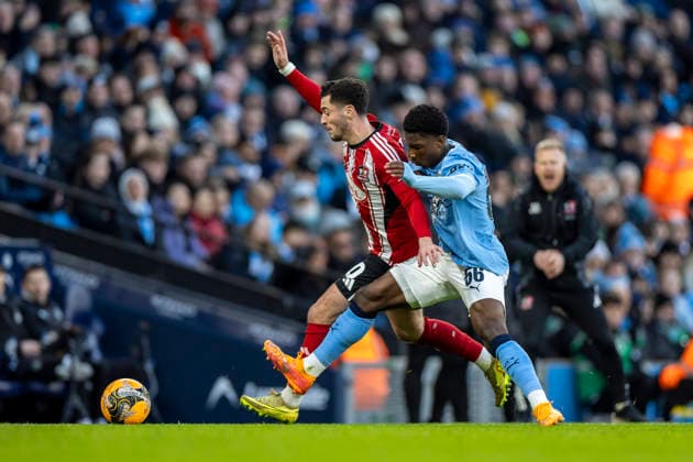 10th January 2026; Etihad Stadium, Manchester, Lancashire, England; FA Cup Football, Manchester City versus Exeter City; Jack Aitchison of Exeter City under pressure from Ryan McAidoo of Manchester City  TimxWilliams