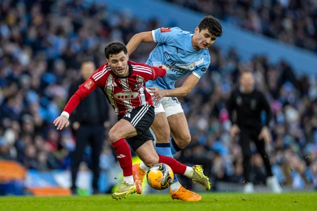 10th January 2026; Etihad Stadium, Manchester, Lancashire, England; FA Cup Football, Manchester City versus Exeter City; Jack Aitchison of Exeter City is tackled by Abdukodir Khusanov of Manchester City  TimxWilliams