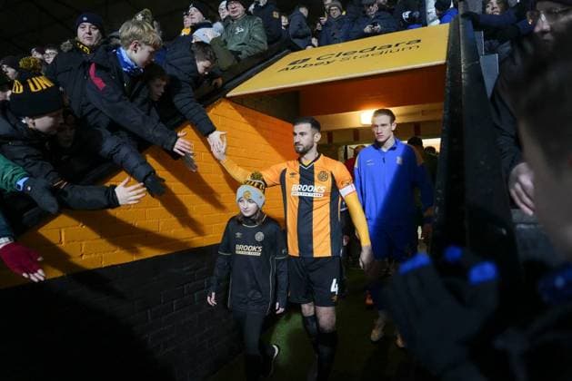 Dominic Ball of Cambridge United high fives the fans waiting above the tunnel as he leads his team out before the start of the match Cambridge United v Birmingham City, Emirates FA Cup, Third Round, Football, Cledara Abbey Stadium, Cambridge, UK - 10 Jan 2026Cambridge Cledara Abbey Stadium United Kingdom EDITORIAL USE ONLY No use with unauthorised audio, video, data, fixture lists, club league logos or live services. Online in-match use limited to 120 images, no video emulation. No use in betting, games or single club league player publications. Copyright: xJedxLeicester Shutterstockx 16246307c