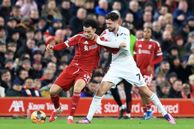 Liverpool, England, 12th January 2026. Curtis Jones of Liverpool and Corey O Keeffe of Barnsley challenge for the ball during the Liverpool vs Barnsley FA Cup match at Anfield, Liverpool. Picture credit should read: Jessica Hornby Sportimage EDITORIAL USE ONLY. No use with unauthorised audio, video, data, fixture lists, club league logos or live services. Online in-match use limited to 120 images, no video emulation. No use in betting, games or single club league player publications. SPI_065_JH_Liverpool_Barnsley SPI-4444-0065