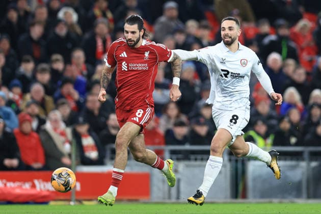 Liverpool, England, 12th January 2026. Dominik Szoboszlai of Liverpool under pressure from Adam Phillips of Barnsley during the Liverpool vs Barnsley FA Cup match at Anfield, Liverpool. Picture credit should read: Jessica Hornby Sportimage EDITORIAL USE ONLY. No use with unauthorised audio, video, data, fixture lists, club league logos or live services. Online in-match use limited to 120 images, no video emulation. No use in betting, games or single club league player publications. SPI_070_JH_Liverpool_Barnsley SPI-4444-0070