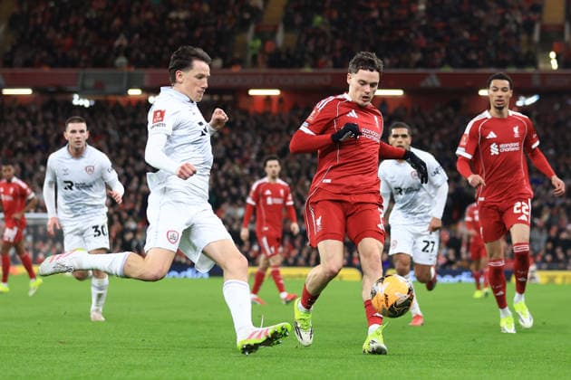 Liverpool, England, 12th January 2026. Mael de Gevigney of Barnsley and Florian Wirtz of Liverpool challenge for the ball during the Liverpool vs Barnsley FA Cup match at Anfield, Liverpool. Picture credit should read: Jessica Hornby Sportimage EDITORIAL USE ONLY. No use with unauthorised audio, video, data, fixture lists, club league logos or live services. Online in-match use limited to 120 images, no video emulation. No use in betting, games or single club league player publications. SPI_098_JH_Liverpool_Barnsley SPI-4444-0098
