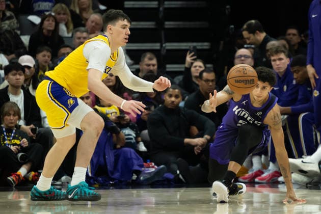 January 12, 2026, Sacramento, Ca, USA: Sacramento Kings guard Nique Clifford (5) dives for loose ball against Los Angeles Lakers forward Jake LaRavia (12) in the second half during a game at the Golden 1 Center on Monday, Jan. 12, 2026 in Sacramento. Sacramento USA - ZUMAj89_ 20260112_zaf_j89_008 Copyright: xPaulxKitagakixJr.x