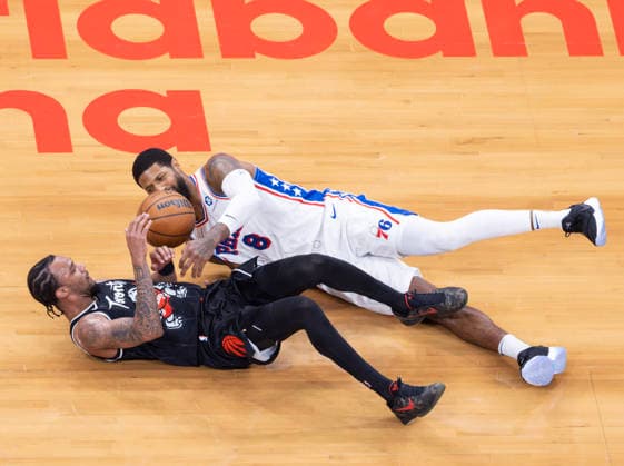 (260113) -- TORONTO, Jan. 13, 2026 -- A.J. Lawson (bottom) of Toronto Raptors vies with Paul George of Philadelphia 76ers during the 2025-2026 NBA, Basketball Herren, USA regular season game between Toronto Raptors and Philadelphia 76ers in Toronto, Canada, on Jan. 12, 2026. (Photo by Xinhua) (SP)CANADA-TORONTO-BASKETBALL-NBA-76ERS VS RAPTORS ZouxZheng 