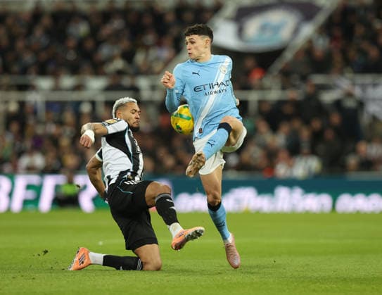 Newcastle Upon Tyne, England, 13th January 2026. Joelinton (L) of Newcastle United in action with Phil Foden of Manchester City during the Newcastle United vs Manchester City Carabao Cup match at St. James Park, Newcastle Upon Tyne. Picture credit should read: Nigel Roddis Sportimage EDITORIAL USE ONLY. No use with unauthorised audio, video, data, fixture lists, club league logos or live services. Online in-match use limited to 120 images, no video emulation. No use in betting, games or single club league player publications. SPI_017_NR_NEWC_MANC SPI-4449-0017