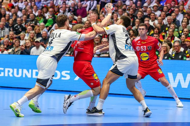15.01.2026, Handball, Men s EHF EURO 2026, Deutschland - Östereich, Jyske Bank Boxen in Herning, Dänemark, Preliminary Round: Johannes Golla (Germany 04) und Renars Uscins (Germany 23) machen Lukas Hutecek (Austria 72) an der Linie fest Dänemark