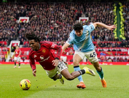 Manchester, England, 17th January 2026. Patrick Dorgu of Manchester United, ManU and Abdukodir Khusanov of Manchester City during the Manchester United vs Manchester City Premier League match at Old Trafford, Manchester. Picture credit should read: Andrew Yates Sportimage EDITORIAL USE ONLY. No use with unauthorised audio, video, data, fixture lists, club league logos or live services. Online in-match use limited to 120 images, no video emulation. No use in betting, games or single club league player publications. SPI_079_AY_ManUtd_ManCity SPI-4456-0078