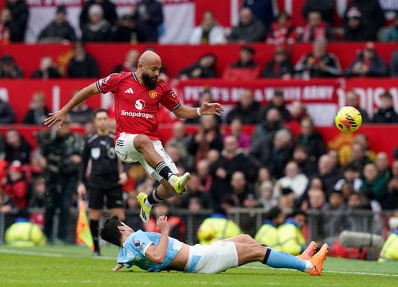 Manchester, England, 17th January 2026. Abdukodir Khusanov of Manchester City tackles Bryan Mbeumo of Manchester United, ManU during the Manchester United vs Manchester City Premier League match at Old Trafford, Manchester. Picture credit should read: Andrew Yates Sportimage EDITORIAL USE ONLY. No use with unauthorised audio, video, data, fixture lists, club league logos or live services. Online in-match use limited to 120 images, no video emulation. No use in betting, games or single club league player publications. SPI_084_AY_ManUtd_ManCity SPI-4456-0083