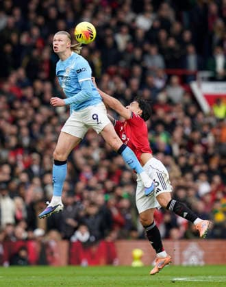 Manchester, England, 17th January 2026. Erling Haaland of Manchester City leaps above Lisandro Martinez of Manchester United, ManU during the Manchester United vs Manchester City Premier League match at Old Trafford, Manchester. Picture credit should read: Andrew Yates Sportimage EDITORIAL USE ONLY. No use with unauthorised audio, video, data, fixture lists, club league logos or live services. Online in-match use limited to 120 images, no video emulation. No use in betting, games or single club league player publications. SPI_086_AY_ManUtd_ManCity SPI-4456-0085