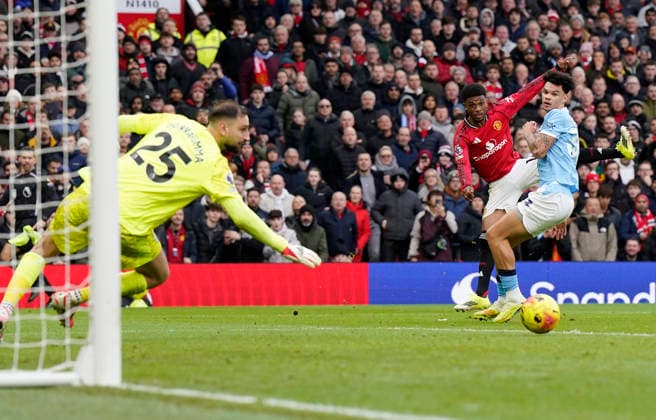 Manchester, England, 17th January 2026. Amad Diallo of Manchester United, ManU send a shot across the goal during the Manchester United vs Manchester City Premier League match at Old Trafford, Manchester. Picture credit should read: Andrew Yates Sportimage EDITORIAL USE ONLY. No use with unauthorised audio, video, data, fixture lists, club league logos or live services. Online in-match use limited to 120 images, no video emulation. No use in betting, games or single club league player publications. SPI_094_AY_ManUtd_ManCity SPI-4456-0093