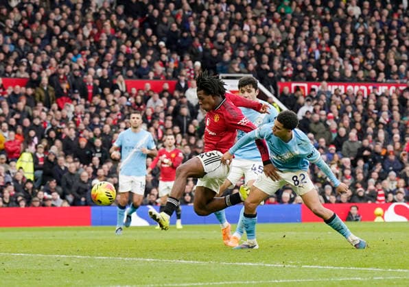 Manchester, England, 17th January 2026. Patrick Dorgu of Manchester United, ManU scores their second goal during the Manchester United vs Manchester City Premier League match at Old Trafford, Manchester. Picture credit should read: Andrew Yates Sportimage EDITORIAL USE ONLY. No use with unauthorised audio, video, data, fixture lists, club league logos or live services. Online in-match use limited to 120 images, no video emulation. No use in betting, games or single club league player publications. SPI_097_AY_ManUtd_ManCity SPI-4456-0096