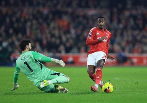 Nottingham, England, 17th January 2026. David Raya of Arsenal rushes out to deny Callum Hudson-Odoi of Nottingham Forest during the Nottingham Forest vs Arsenal Premier League match at the City Ground, Nottingham. Picture credit should read: Jessica Hornby Sportimage EDITORIAL USE ONLY. No use with unauthorised audio, video, data, fixture lists, club league logos or live services. Online in-match use limited to 120 images, no video emulation. No use in betting, games or single club league player publications. SPI_037_JH_FOREST_ARSENAL SPI-4459-0037