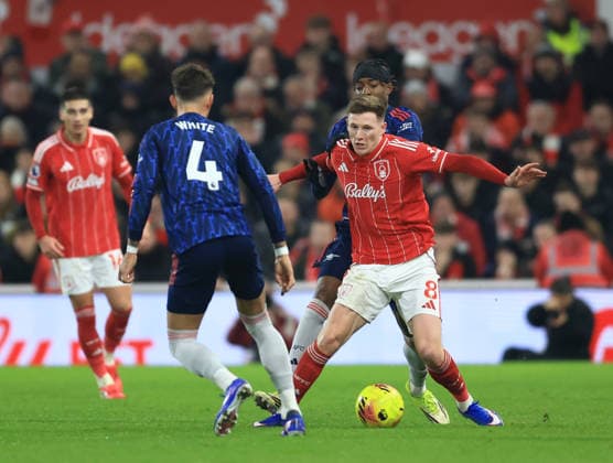 Nottingham, England, 17th January 2026. Elliot Anderson of Nottingham Forest tackled by Noni Madueke of Arsenal during the Nottingham Forest vs Arsenal Premier League match at the City Ground, Nottingham. Picture credit should read: Jessica Hornby Sportimage EDITORIAL USE ONLY. No use with unauthorised audio, video, data, fixture lists, club league logos or live services. Online in-match use limited to 120 images, no video emulation. No use in betting, games or single club league player publications. SPI_043_JH_FOREST_ARSENAL SPI-4459-0041