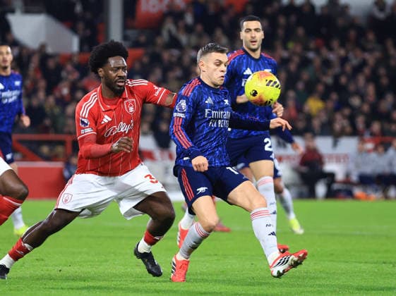 Nottingham, England, 17th January 2026. Leandro Trossard of Arsenal (r) marshalled by Ola Aina of Nottingham Forest (l) during the Nottingham Forest vs Arsenal Premier League match at the City Ground, Nottingham. Picture credit should read: Jessica Hornby Sportimage EDITORIAL USE ONLY. No use with unauthorised audio, video, data, fixture lists, club league logos or live services. Online in-match use limited to 120 images, no video emulation. No use in betting, games or single club league player publications. SPI_054_JH_FOREST_ARSENAL SPI-4459-0054