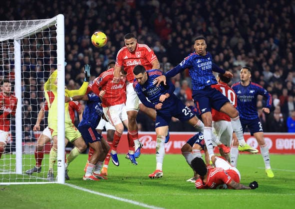Nottingham, England, 17th January 2026. Murillo of Nottingham Forest heads the ball away under pressure from Mikel Merino and Gabriel of Arsenal during the Nottingham Forest vs Arsenal Premier League match at the City Ground, Nottingham. Picture credit should read: Jessica Hornby Sportimage EDITORIAL USE ONLY. No use with unauthorised audio, video, data, fixture lists, club league logos or live services. Online in-match use limited to 120 images, no video emulation. No use in betting, games or single club league player publications. SPI_056_JH_FOREST_ARSENAL SPI-4459-0056