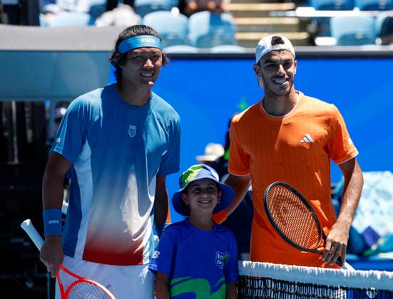 (260118) -- MELBOURNE, Jan. 18, 2026 -- Zhang Zhizhen (L) of China and Francisco Cerundolo (R) of Argentina pose for photos with a ball boy ahead of their men s singles first round match at the Australian Open tennis tournament 2026 in Melbourne, Australia, Jan. 18, 2026. ) (SP)AUSTRALIA-MELBOURNE-AUSTRALIAN OPEN-MEN S SINGLES-DAY 1 MaxPing 