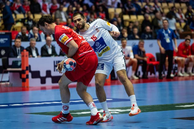 HERNING, DENMARK - JANUARY 19: Uros Kojadinovic (Serbia, 15) against Lukas Herburger (Austria, 26) during the EHF EURO 2026 match between Austria vs Serbia at Jyske Bank Boxen Arena on matchday 3 of the Group Matches Group A on January 19, 2026 in Herning, Denmark. Midtjylland Denmark Copyright: xMarioxM.xKobergx