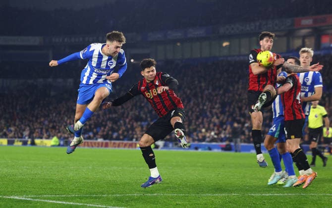 Brighton and Hove, England, 19th January 2026. Jack Hinshelwood of Brighton and Hove Albion heads the ball towards goal which appears to hit the arm of Marcos Senesi of Bournemouth during the Brighton and Hove Albion vs AFC Bournemouth Premier League match at the AMEX Stadium, Brighton and Hove. Picture credit should read: Paul Terry Sportimage EDITORIAL USE ONLY. No use with unauthorised audio, video, data, fixture lists, club league logos or live services. Online in-match use limited to 120 images, no video emulation. No use in betting, games or single club league player publications. SPI_031_PT_Brighton_Bournemouth SPI-4463-0031