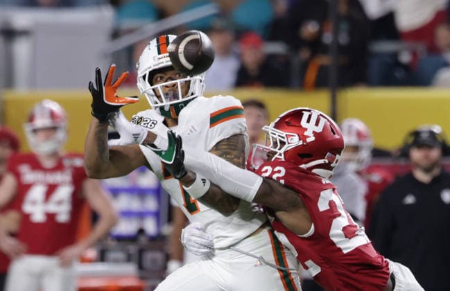 Indiana defensive back Jamari Sharpe (22) breaks up a pass intended for Miami wide receiver CJ Daniels (7) in the third quarter of the NCAA, College League, USA College Football Championship game at Hard Rock Stadium in Miami, Florida, on Monday, January 19, 2026.  MIA20260119836 AARONxJOSEFCZYK