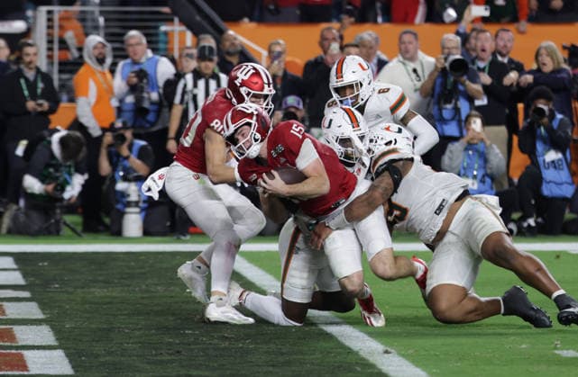 Indiana quarterback Fernando Mendoza (15) lunges across the goal line for a 12-yard touchdown against Miami in the fourth quarter of the NCAA, College League, USA College Football Championship game at Hard Rock Stadium in Miami, Florida, on Monday, January 19, 2026.  MIA20260119855 AARONxJOSEFCZYK
