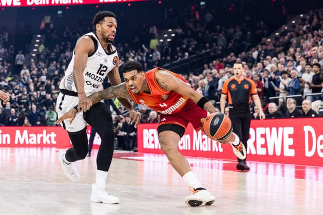 MUNICH, GERMANY - JANUARY 20: Xavier Rathan-Mayes (FC Bayern Muenchen, 4) controls the ball against Sterling Brown (Partizan Mozzart Bet Belgrade, 12) during the Turkish Airlines EuroLeague match between FC Bayern Muenchen vs. Partizan Mozzart Bet Belgrade at SAP Garden on round 23 of Turkish Airlines EuroLeague on January 20, 2026 in Munich, Germany. Bavaria Germany Copyright: xSteffiexWunderlx