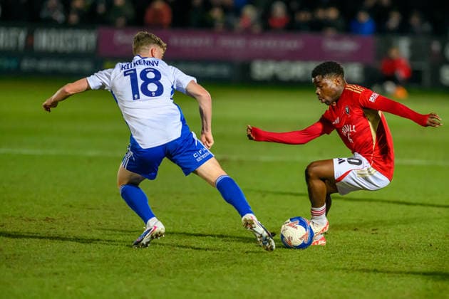 Salford City v Swindon Town - Emirates FA Cup Third Round Gavin Kilkenny of Swindon Town FC tries to tackle Kelly Nmai of Salford City FC during the Emirates FA Cup Third Round match between Salford City and Swindon Town at The Peninsula Stadium in Salford, on January 20, 2026. Salford Lancashire United Kingdom  Copyright: xMIxNewsx originalFilename:fletcher-salfordc260120_np7Wv.jpg