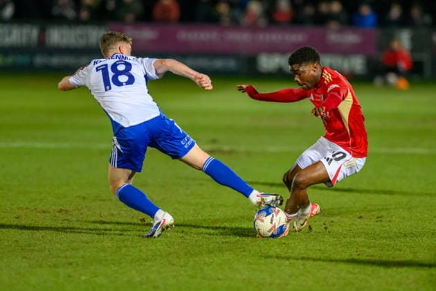 Salford City v Swindon Town - Emirates FA Cup Third Round Gavin Kilkenny of Swindon Town FC tries to tackle Kelly Nmai of Salford City FC during the Emirates FA Cup Third Round match between Salford City and Swindon Town at The Peninsula Stadium in Salford, on January 20, 2026. Salford Lancashire United Kingdom  Copyright: xMIxNewsx originalFilename:fletcher-salfordc260120_npOlB.jpg