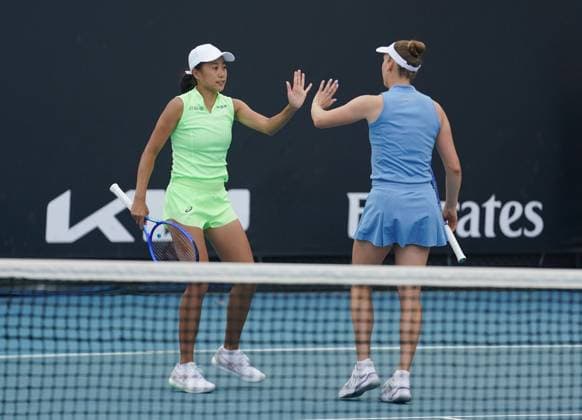 (260121) -- MELBOURNE, Jan. 21, 2026 -- Zhang Shuai (L) Elise Mertens celebrate during the women s doubles 1st round match between Zhang Shuai (China) Elise Mertens (Belgium) and Sorana Cirstea (Romania) Anna Kalinskaya (Russia) at the Australian Open tennis tournament in Melbourne, Australia, Jan. 21, 2026. (Photo by Xinhua) (SP)AUSTRALIA-MELBOURNE-TENNIS-AUSTRALIAN OPEN-WOMEN S DOUBLES-DAY 4 WangxShen 