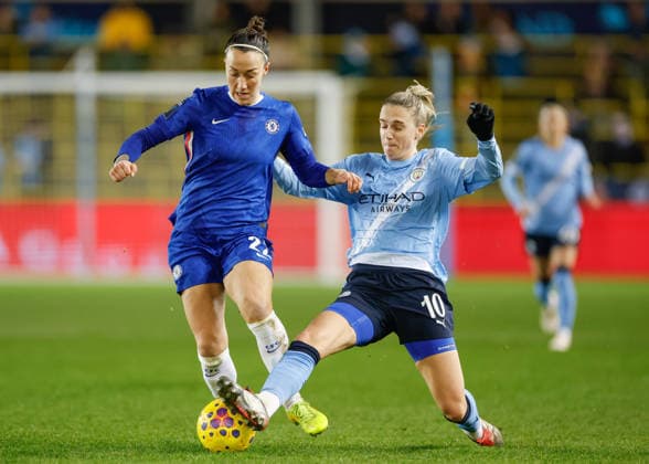 Manchester, England, 21st January 2026. Vivianne Miedema of Manchester City tackles Lucy Bronze of Chelsea during the Manchester City Women vs Chelsea Women Subway Women s League Cup match at the Academy Stadium, Manchester. Picture credit should read: Cody Froggatt Sportimage EDITORIAL USE ONLY. No use with unauthorised audio, video, data, fixture lists, club league logos or live services. Online in-match use limited to 120 images, no video emulation. No use in betting, games or single club league player publications. SPI_015_CF_MANCHESTER_CITY_WOMEN_V_CHELSEA_WOMEN SPI-4471-0015