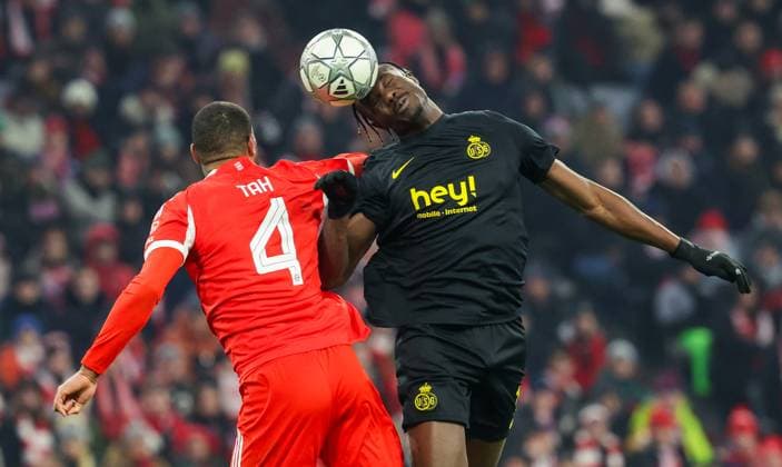Bayern s Jonathan Tah and Union s Promise David fight for the ball during a soccer game between German FC Bayern Munich and Belgian Royale Union Saint-Gilloise, on Wednesday 21 January 2026 in Munich, on the seventh day of the League phase of the UEFA Champions League tournament. VIRGINIExLEFOUR  x157572902x