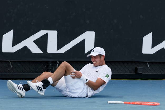 (260122) -- MELBOURNE, Jan. 22, 2026 -- Wu Yibing reacts as he lies on the court during the men s singles 2nd round match between Wu Yibing of China and Eliot Spizzirri of the United States at the Australian Open tennis tournament in Melbourne, Australia, Jan. 22, 2026. ) (SP)AUSTRALIA-MELBOURNE-TENNIS-AUSTRALIAN OPEN-MEN S SINGLES MaxPing 