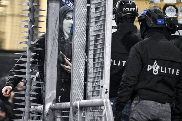 A masked Genk supporter provokes Dutch police ahead of a soccer game between Dutch soccer club FC Utrecht and Belgian KRC Genk, on Thursday 22 January 2026 in Utrecht, Netherlands, the seventh game (out of 8) in the league phase of the UEFA Europa League competition. TOM GOYVAERTS TomxGoyvaerts  x157803782x