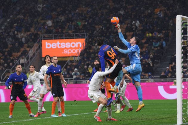 Milan, Italy, 23rd January 2026. Simone Scuffet of Pisa SC punches the ball clear from Francesco Pio Esposito of FC Internazionale during the Internazionale vs Pisa SC Serie A match at Giuseppe Meazza, Milan. Picture credit should read: Jonathan Moscrop Sportimage EDITORIAL USE ONLY. No use with unauthorised audio, video, data, fixture lists, club league logos or live services. Online in-match use limited to 120 images, no video emulation. No use in betting, games or single club league player publications. SPI_115_JM_INTER_PISA_ SPI-4419-0115