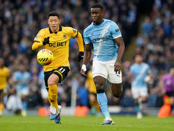 Manchester, England, 24th January 2026. Marc Guehi of Manchester City (R) is challenged by Hwang Hee-Chan of Wolverhampton Wanderers during the Manchester City vs Wolverhampton Wanderers Premier League match at the Etihad Stadium, Manchester. Picture credit should read: Andrew Yates Sportimage EDITORIAL USE ONLY. No use with unauthorised audio, video, data, fixture lists, club league logos or live services. Online in-match use limited to 120 images, no video emulation. No use in betting, games or single club league player publications. SPI_014_AY_MAN_CITY_WOLVES SPI-4473-0014