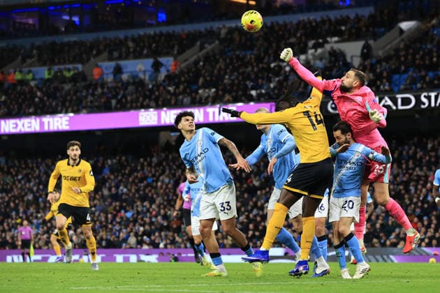 24th January 2026; Etihad Stadium, Manchester, Lancashire, England; Premier League Football, Manchester City versus Wolverhampton Wanderers; Gianluigi Donnarumma of Manchester City leaps above Tolu Arokodare of Wolverhampton Wanderers to punch the ball clear  DavidxBlunsden Content restricted for UK based newspaper