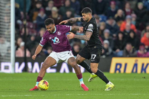 24th January 2026; Turf Moor, Burnley, Lancashire, England; Premier League Football, Burnley versus Tottenham Hotspur; Cristian Romero of Tottenham Hotspur tussles with Lyle Foster of Burnley for the ball  LeexDurkin Content restricted for UK based newspaper