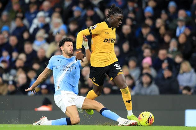 24th January 2026; Etihad Stadium, Manchester, Lancashire, England; Premier League Football, Manchester City versus Wolverhampton Wanderers; Matheus Nunes of Manchester City slides in to tackle Mateus Mane of Wolverhampton Wanderers  DavidxBlunsden Content restricted for UK based newspaper