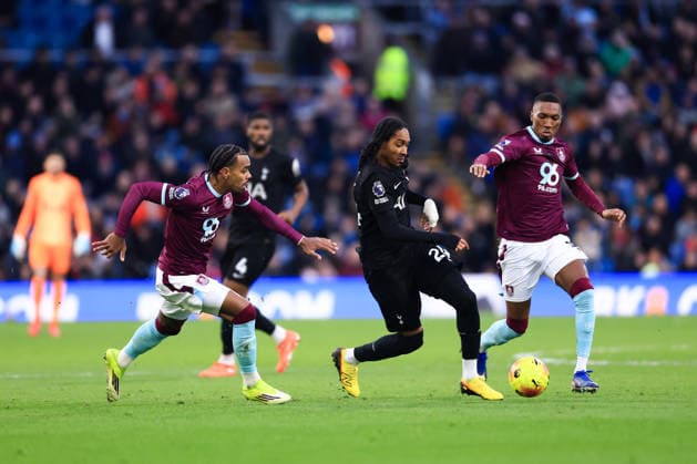 Burnley, England, 24th January 2026. Djed Spence of Tottenham Hotspur is challenged by Lucas Pires (L) and Jaidon Anthony of Burnley during the Burnley vs Tottenham Hotspur Premier League match at Turf Moor, Burnley. Picture credit should read: Jessica Hornby Sportimage EDITORIAL USE ONLY. No use with unauthorised audio, video, data, fixture lists, club league logos or live services. Online in-match use limited to 120 images, no video emulation. No use in betting, games or single club league player publications. SPI_059_JH_BURNLEY_TOTTENHAM SPI-4474-0058