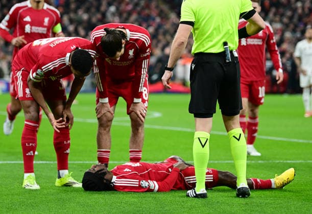 Liverpool, England, 28th January 2026. Jeremie Frimpong of Liverpool lies injured leading to him leaving the game after 2 minutes during the Liverpool vs Qarabag FK UEFA Champions League match at Anfield, Liverpool. Picture credit should read: Harriet Massey Sportimage EDITORIAL USE ONLY. No use with unauthorised audio, video, data, fixture lists, club league logos or live services. Online in-match use limited to 120 images, no video emulation. No use in betting, games or single club league player publications. SPI_026_HM_Lpool_Qarabag SPI-4487-0025
