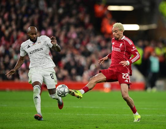 Liverpool, England, 28th January 2026. Kevin Medina of FK Qarabag and Hugo Ekitike of Liverpool during the Liverpool vs Qarabag FK UEFA Champions League match at Anfield, Liverpool. Picture credit should read: Harriet Massey Sportimage EDITORIAL USE ONLY. No use with unauthorised audio, video, data, fixture lists, club league logos or live services. Online in-match use limited to 120 images, no video emulation. No use in betting, games or single club league player publications. SPI_052_HM_Lpool_Qarabag SPI-4487-0051